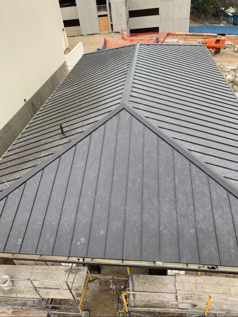 Commercial metal roof construction with crane equipment in Newburgh